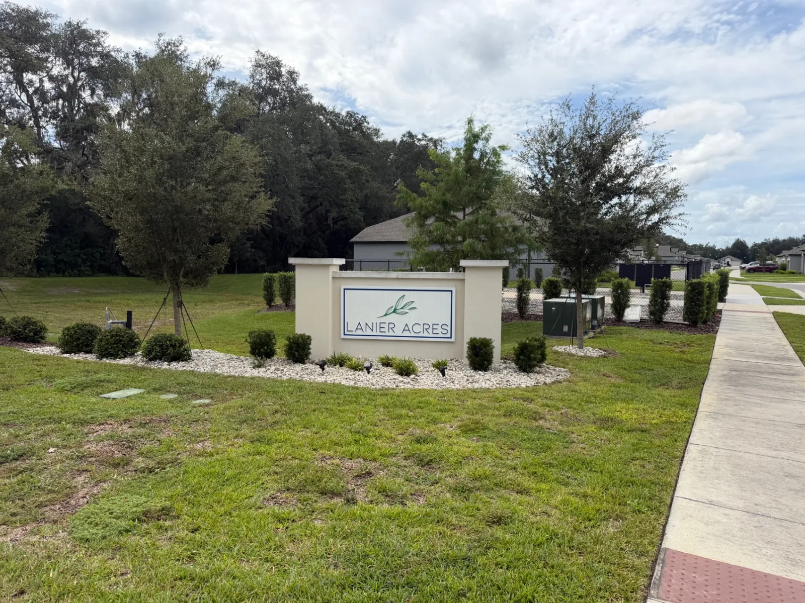 Lanier Acres community entrance with fresh river rock and shrubs