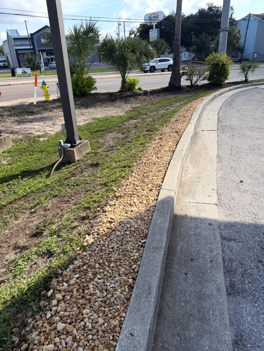 New river rock border along a commercial curb