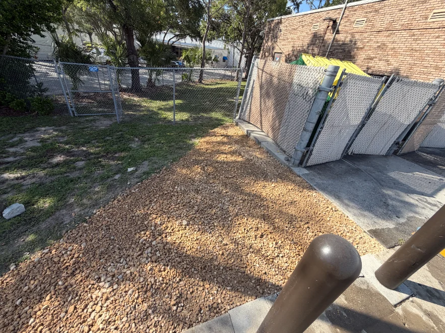 Fresh rock ground cover by a dumpster enclosure