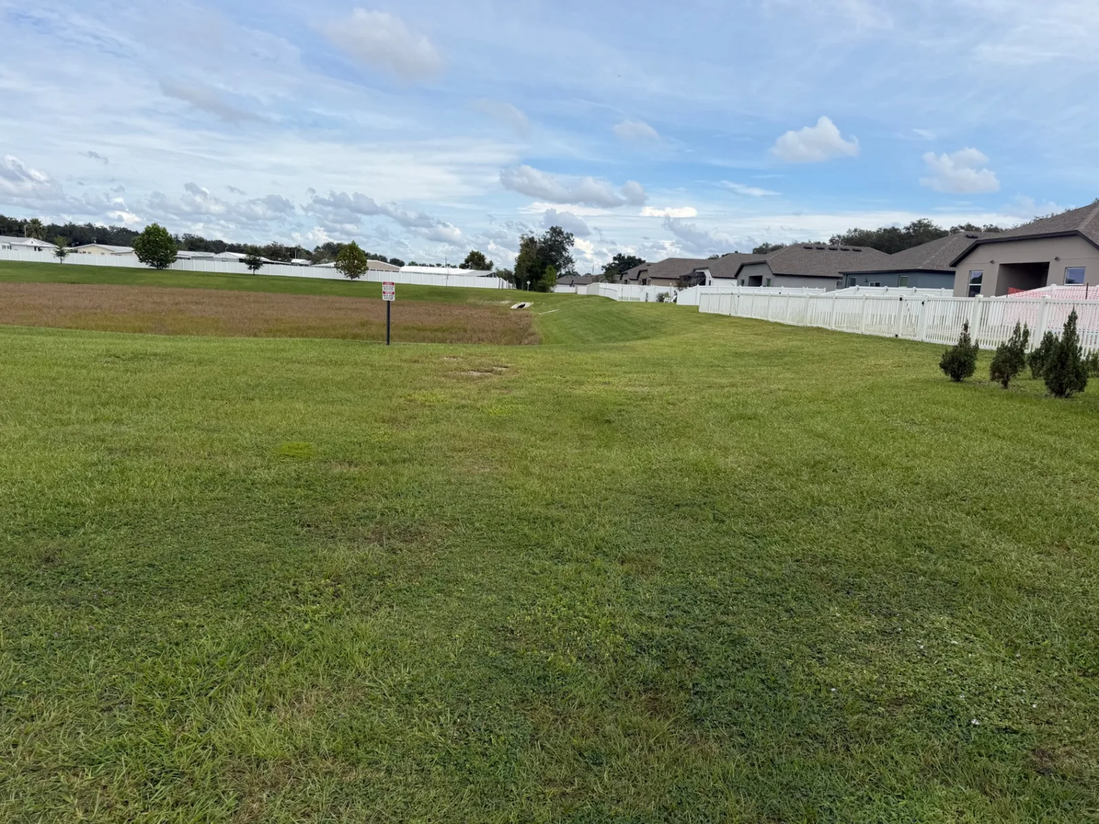 Mowed retention area along a residential fence line
