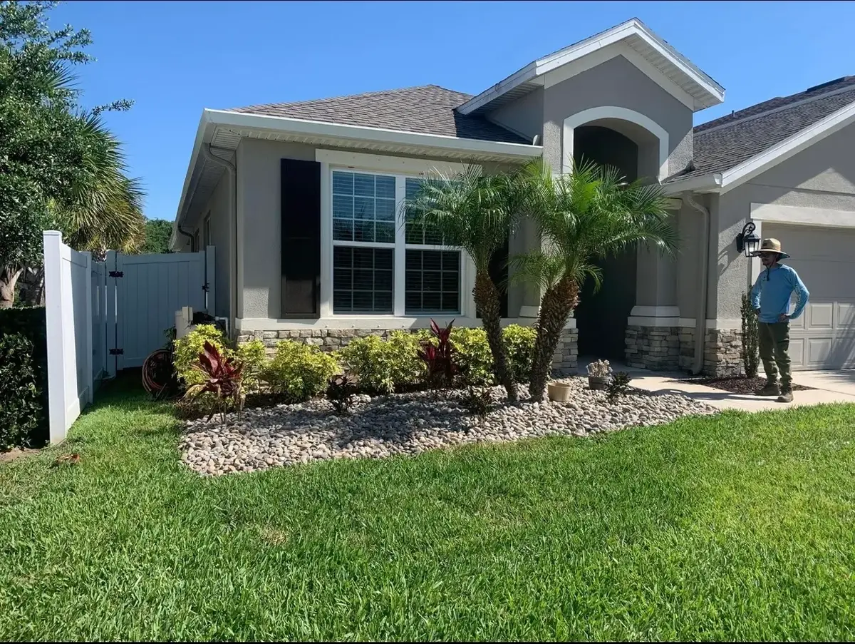 Finished residential front yard with river rock beds