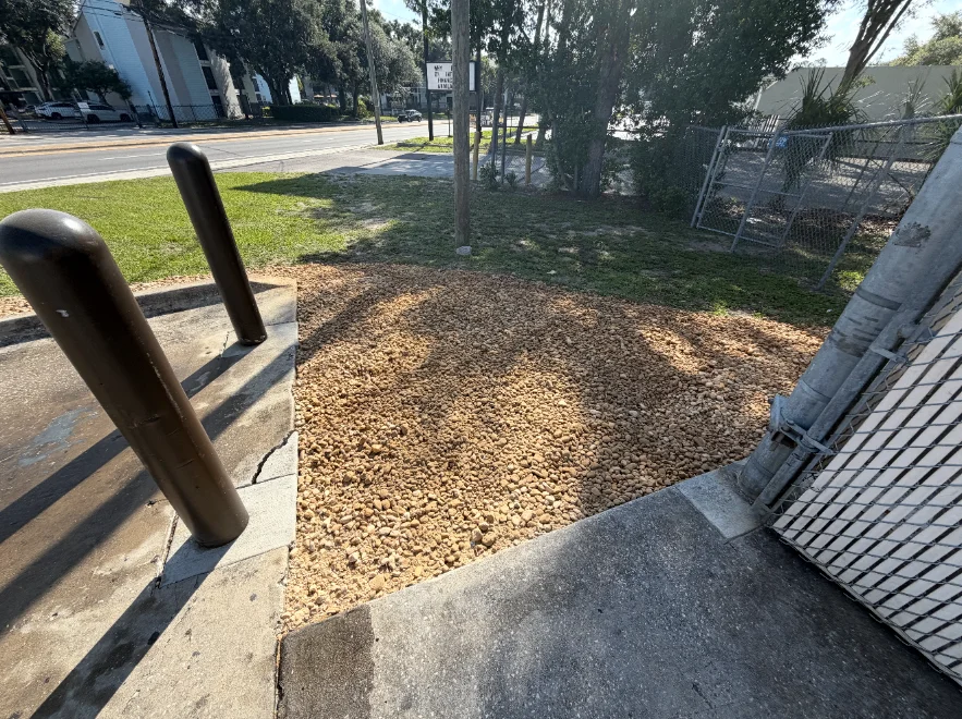 New river rock bed beside a commercial building
