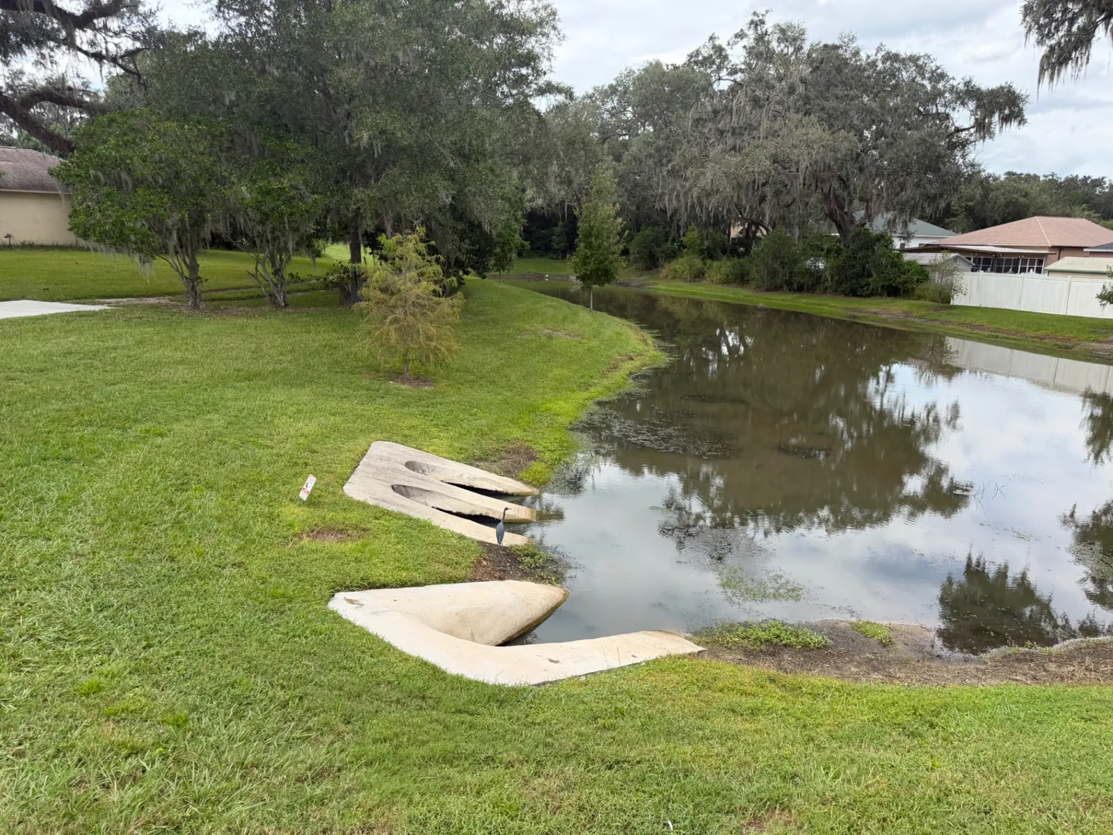 Clean, trimmed pond bank around drainage structures